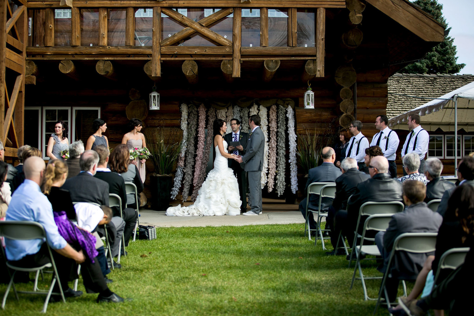 outside wedding ceremony photographed from the back guest seated