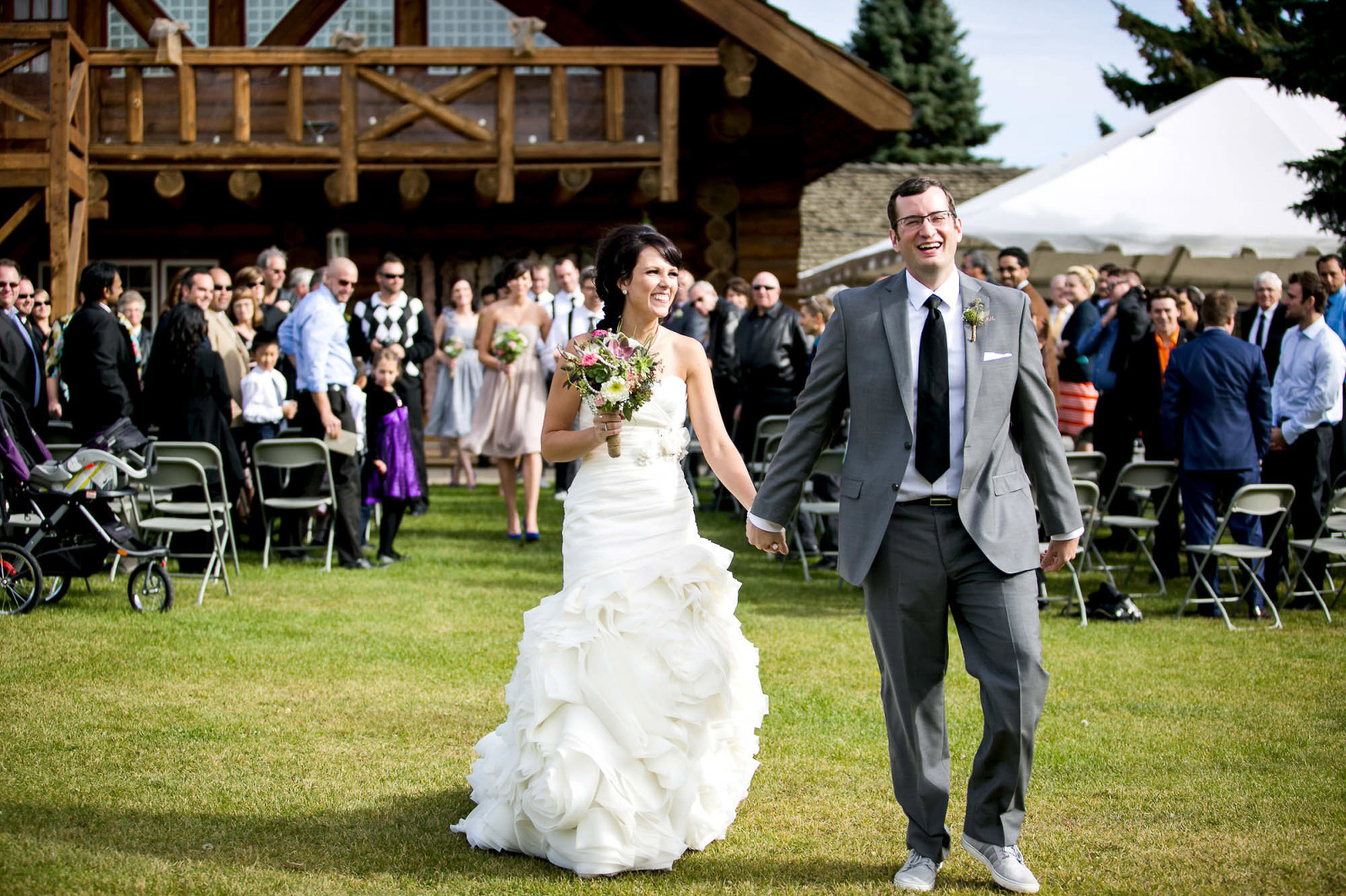 bride and groom walking down the isle being very happy and smiling